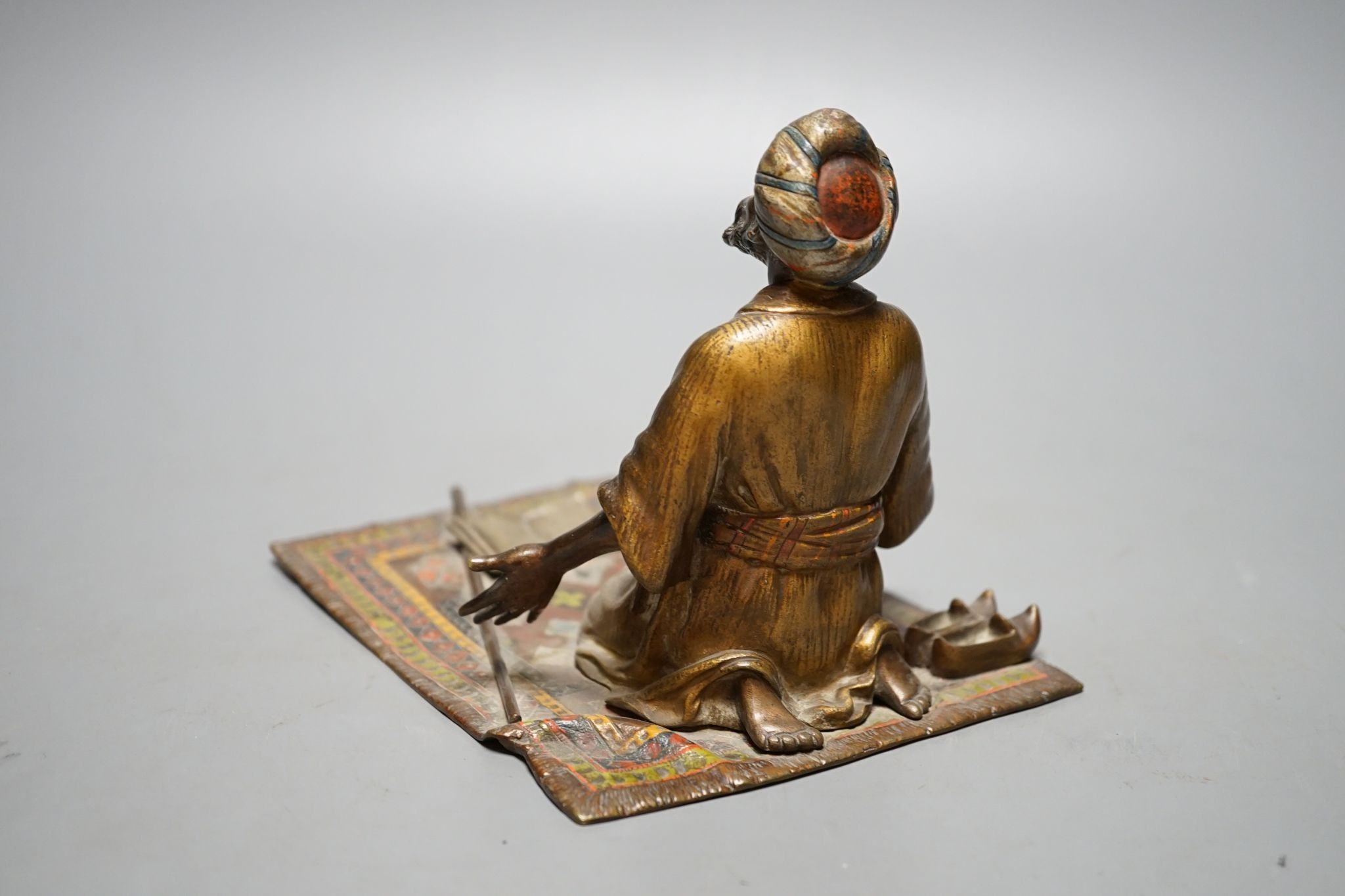 An enamelled, cold-painted bronze kneeling figure, unsigned, probably Franz Bergman, 16 cms deep x 13 cms high.